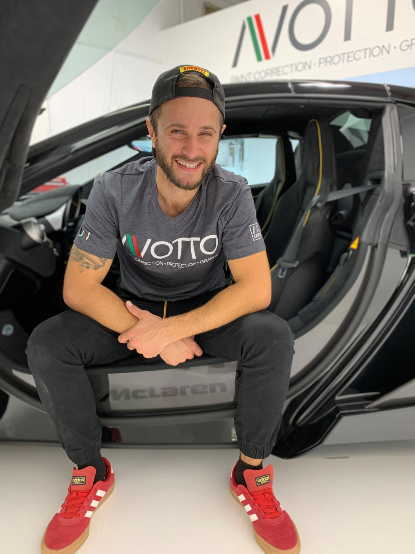Anthony in the shop, sitting on a McLaren door sill